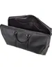 An open black leather duffel bag. Produktbild-Vorschau