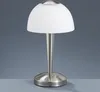 A modern LED table lamp with a brushed nickel finish and a frosted white dome shade, presented against a plain gray background. Produktbild-Vorschau