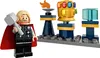 A LEGO minifigure of Thor holding Mjolnir, standing next to a display of the Infinity Gauntlet and other items on a LEGO base. Produktbild-Vorschau