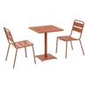 A square garden table with two chairs, all in an orange color, on a white background. Produktbild-Vorschau