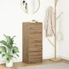 A tall, narrow wooden cabinet with drawers is placed next to a coat rack with a coat and a handbag hanging on it. A potted plant is on the left side of the cabinet. Produktbild-Vorschau