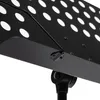 A close-up view of a black metal music stand, focusing on the hinge mechanism and perforated surface. Produktbild-Vorschau