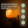 A Himalayan salt night light plugged into a wall socket, with text and icons describing its features. Produktbild-Vorschau