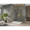 A modern bathroom with a gold-framed glass shower enclosure and a white shower tray, surrounded by large gray marble tiles and light wood flooring. Plants add a touch of nature. Podgląd zdjęcia produktu