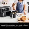 A person is using a Ninja air fryer in a kitchen setting, with a cooked chicken and food in the air fryer basket. Produktbild-Vorschau