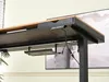 Underside of a desk showing cable management and a drawer. Podgląd zdjęcia produktu
