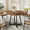 A round dining table with chairs in a dining room setting. Podgląd zdjęcia produktu