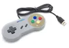 A gray USB game controller with a black cable, placed on a white background. Náhľad obrázku produktu
