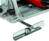 A close-up view of a power tool's base and a metal guide. Produktbild-Vorschau