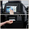 A split image showing the front and back of a car seat organizer. The top shows a tablet in a holder and a water bottle in a side pocket. The bottom shows a tissue dispenser and other storage pockets. Anteprima dell’immagine prodotto