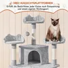 A cat is sitting on a multi-level cat tree with scratching posts and platforms. The background is a light wood-paneled wall. Produktbild-Vorschau