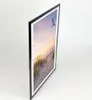 A framed picture of a beach scene with a bird flying in the sky. Produktbild-Vorschau