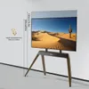 A TV stand with a TV displaying a desert landscape, shown against a plain wall. Podgląd zdjęcia produktu