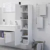 A white bathroom cabinet with its doors open, showing shelves with various items, next to a sink and a towel rack. Náhled obrázku produktu