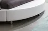 A close-up view of the side of a white round bed frame with a dark gray pillow on top. Produktbild-Vorschau