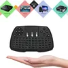 A hand holding a black wireless keyboard with a touchpad, with marketing graphics above showing various devices it can connect to. Produktbild-Vorschau