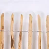 A close-up view of a wooden fence made of vertical wooden stakes bound together by wire. Produktbild-Vorschau