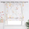 A sheer Roman blind with a branch and leaf pattern is displayed in front of a window. Produktbild-Vorschau