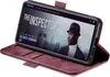 A smartphone in a burgundy flip case is displayed on a white background. Produktbild-Vorschau