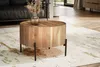 A round wooden coffee table with a metal base is placed on a rug in a living room setting. Produktbild-Vorschau