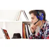 A young man wearing a headset is looking at a tablet on a shelf, with books and a hat also on the shelf. Voir les images du produit