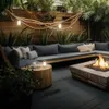 An outdoor patio with a sectional sofa, a fire pit, and a wooden side table with candles and a lamp. Anteprima dell’immagine prodotto