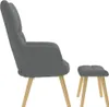 A side view of a gray fabric armchair and a matching footstool with wooden legs, set against a white background. Produktbild-Vorschau