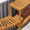 A close-up view of a wooden shelf unit next to a gray inflatable hot tub. Produktbild-Vorschau