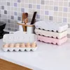 Kitchen counter with egg holders and utensils in the background. Produktbild-Vorschau