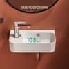 A close-up shot of a white ceramic sink with a chrome faucet and a brown accent on the handle, mounted on a wall with an orange background. A measurement graphic is overlaid on the sink. Anteprima dell’immagine prodotto