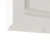 A close-up view of the bottom edge of a white cabinet or shelf with a curved molding. Náhled obrázku produktu