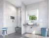 A modern bathroom with a shower, sink, and vanity. Voir les images du produit
