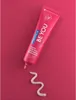 A tube of Curaprox toothpaste with a swirl of toothpaste on a pink background. Náhled obrázku produktu