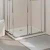 A close-up view of a modern shower tray and enclosure in a bathroom. Produktbild-Vorschau