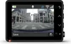 A dash cam mounted in a car, showing a city street scene. Náhľad obrázku produktu