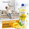 A woman is holding a baby on a couch, with a bottle of cleaning product and lemons in the foreground. Produktbild-Vorschau