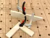 Two clamps are holding together pieces of wood on a workbench. Náhľad obrázku produktu