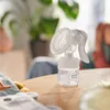 A Philips AVENT hand breast pump is placed on a wooden table. Produktbild-Vorschau