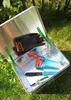 Gardening tools inside an aluminum box, placed on grass. Produktbild-Vorschau