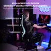 A person is sitting in a gaming chair in a room with gaming equipment. Produktbild-Vorschau
