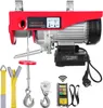 A red electric hoist with various accessories laid out in front of it, including straps, hooks, and a remote control. Voir les images du produit