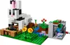 A LEGO Minecraft set featuring a large rabbit structure, a small landscape with water and plants, and a zombie figure. Podgląd zdjęcia produktu