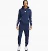 A man wearing a navy blue Nike tracksuit. Produktbild-Vorschau