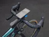 A close-up shot of a bicycle's handlebars with a smartphone mounted on it. Náhled obrázku produktu