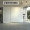 A modern office space with a large white wardrobe and a desk with chairs by a window. Produktbild-Vorschau