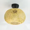 A close-up shot of a woven bamboo ceiling light fixture against a white background. Náhled obrázku produktu