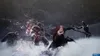 A dark, atmospheric scene with multiple monstrous figures and a central character engaged in combat. Produktbild-Vorschau