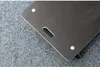 A close-up view of a black platform dolly with a handle, resting on a textured gray surface. Náhľad obrázku produktu