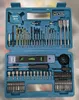 A teal-colored tool case filled with various drill bits, a tape measure, a level, and a screwdriver. Náhled obrázku produktu