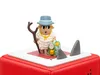 A toy figurine of a sheep dressed as a hiker, standing on a red and white base with two shark fins. Produktbild-Vorschau